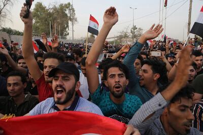 Iraqi protesters wave national flags in front of the provincial council building during a demonstration demanding better public services and jobs, in Basra, 340 miles (550 km) southeast of Baghdad, Iraq, Friday, July 20, 2018. Some thousands have once again taken to the streets in the capital and the southern city of Basra demanding better public services and jobs. (AP Photo/Nabil al-Jurani)