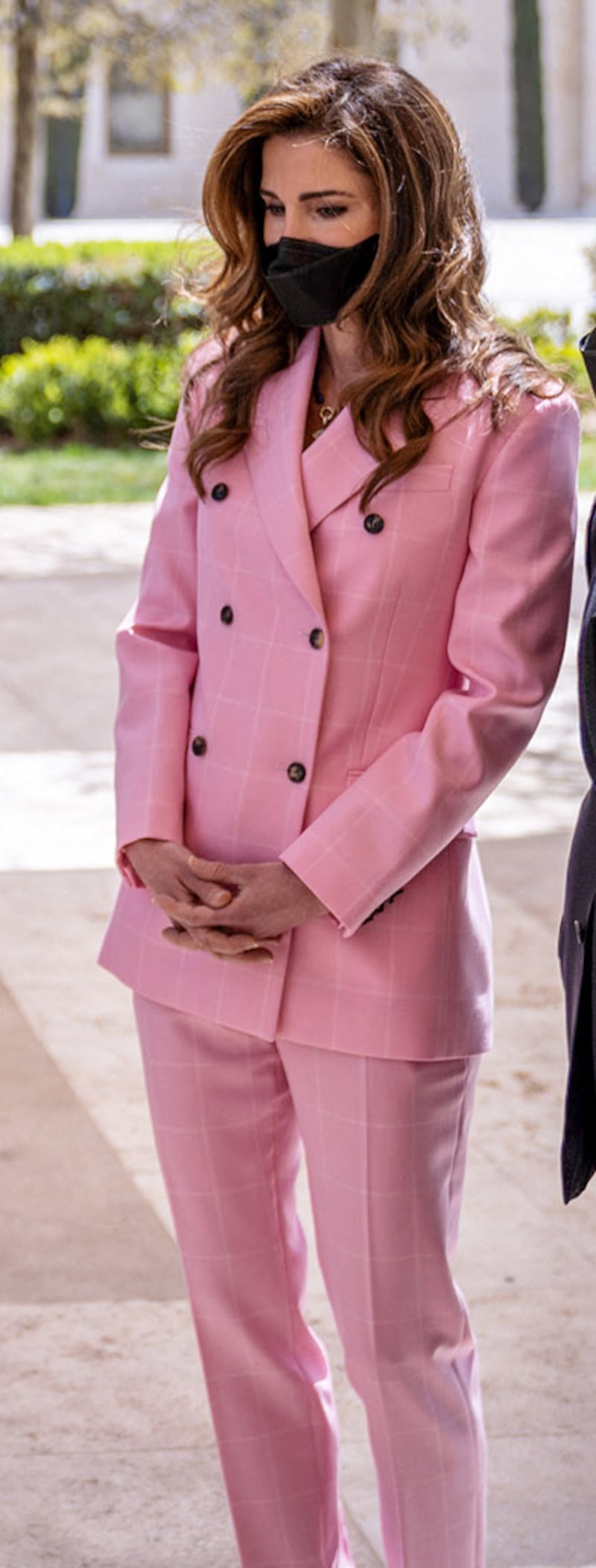 Queen Rania, wearing pink Calvin Klein, during a visit to one of the projects of the Productive Youth Initiative in Amman, Jordan on March 30, 2021. AFP
