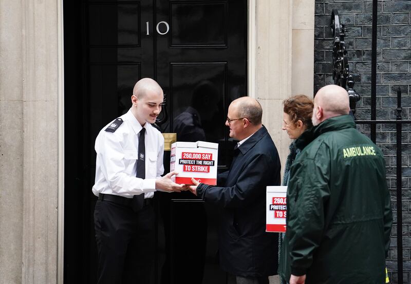 Paul Nowak of the Trades Union Congress and representatives of the Fire Brigades Union and the NHS Ambulance Service hand in a petition to 10 Downing Street. PA