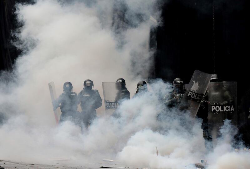 Police are engulfed by a cloud of tear gas at Bolivar square in Bogota, Colombia. AP Photo