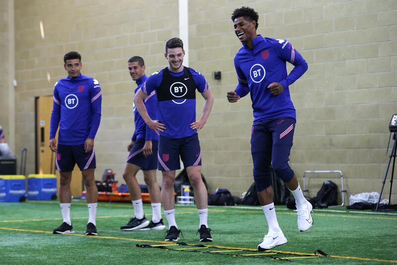 MIDDLESBROUGH, ENGLAND - JUNE 04: Marcus Rashford of England laughs as team mates Declan Rice, Conor Coady and Ben Godfrey look on during the England training session on June 04, 2021 in Middlesbrough, England. (Photo by Eddie Keogh - The FA/The FA via Getty Images)