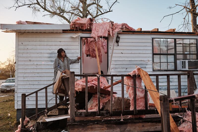 Altharis Threatt stands on the porch of her daughter-in-law's tornado-ravaged trailer home in Mount Vernon, Alabama. EPA