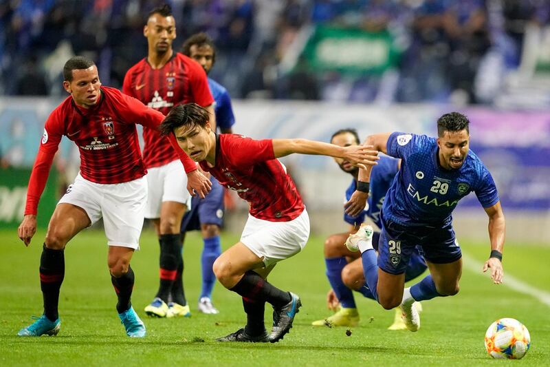 Urawa Reds' Daiki Hashioka, centre, and Al Hilal's Salem Al Dawsari, right, chase for the ball during the second leg of the AFC Champions League final soccer match between Urawa Reds and Al Hilal in Saitama, near Tokyo, Sunday, Nov. 24, 2019. (AP Photo/Christopher Jue)