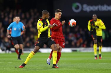 Christian Kabasele of Watford battles for possession with Roberto Firmino of Liverpool in the last game at Vicarage Road before the lockdown. Getty