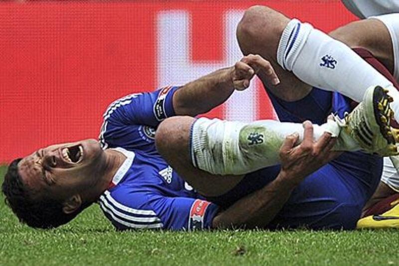 Michael Ballack holds his ankle after the challenge by Portsmouth's Kevin-Price Boateng during the FA Cup final.