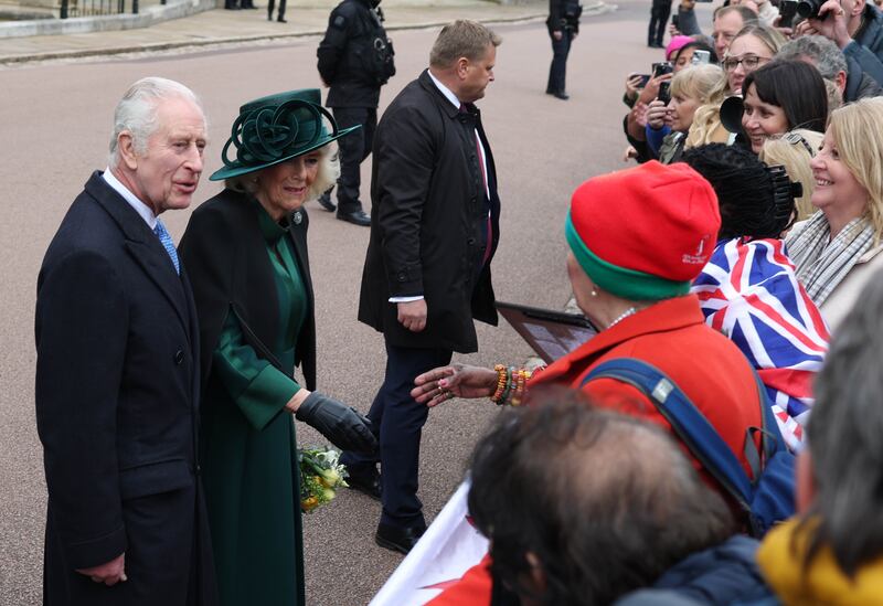 The king told well wishers outside the church that they were 'very brave to stand out here in the cold'. EPA