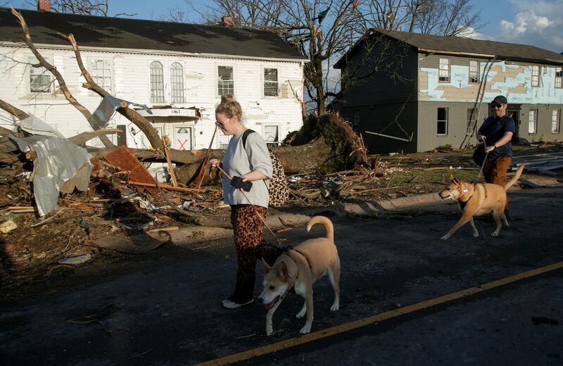 Residents assess the damage. AFP