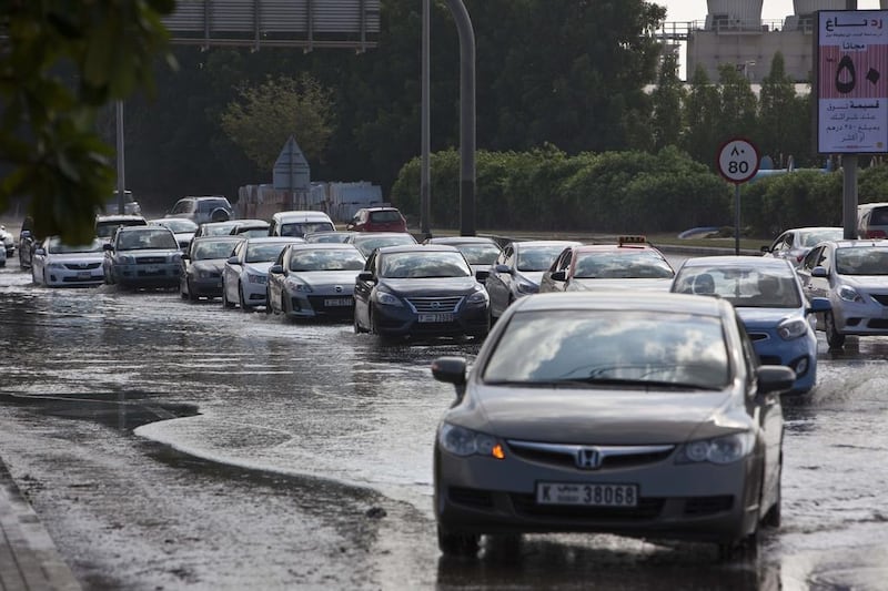 Motorists navigate a flooded section of road near the first traffic light into Discovery Gardens next to the turn for Ibn Batutta Mall. Antonie Robertson/The National