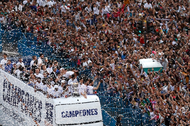 Real Madrid players celebrate with fans in Madrid during the open top bus parade. Reuters