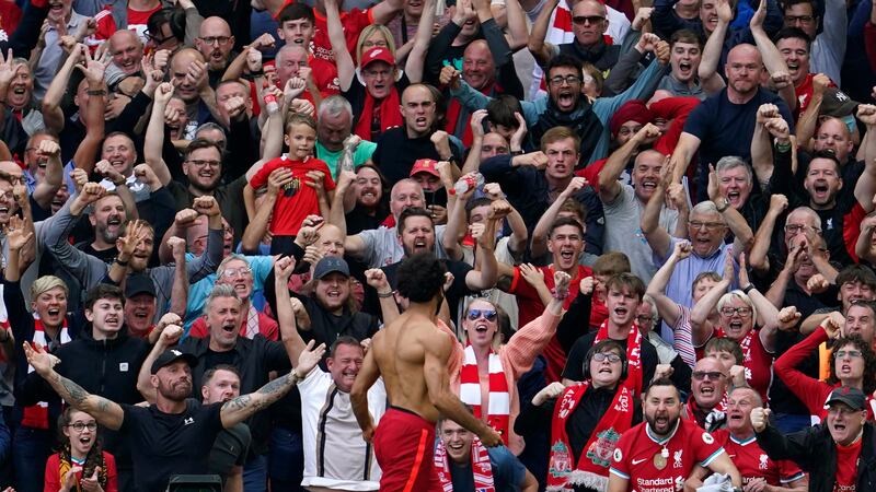 Mohamed Salah celebrates in front of Liverpool fans at Anfield Stadium on September 18, 2021. AP