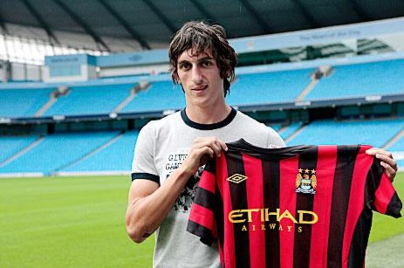 Savic shows off his new Manchester City jersey at Old Trafford.