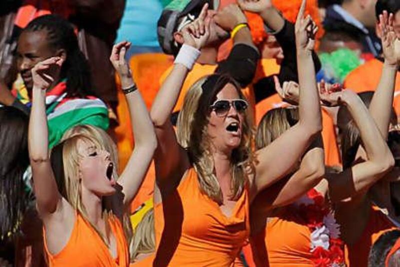Netherlands fans dressed in the team's orange colours cheer during the match against Denmark, which their team won 2-0.