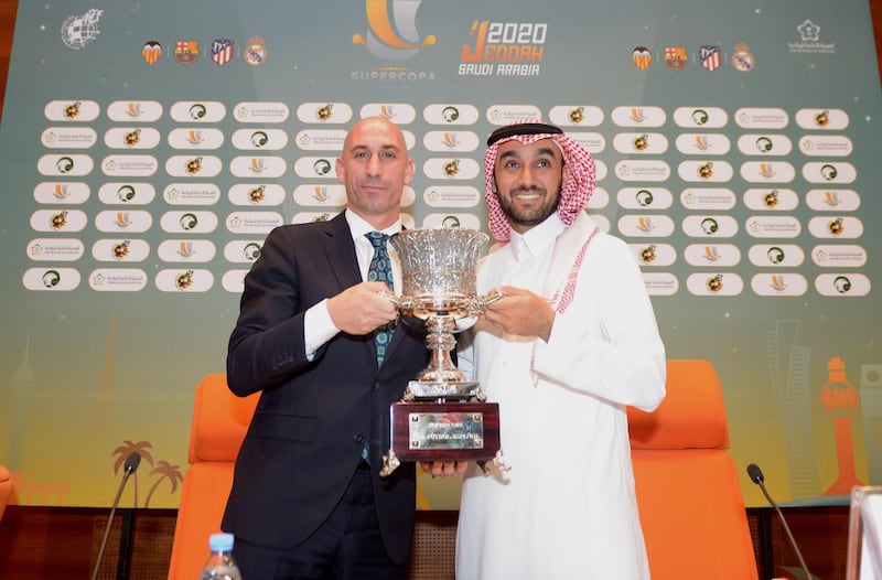 Luis Rubiales, left, and Prince Abdulaziz bin Turki Al-Faisal pose with the Spanish Super Cup trophy. EPA