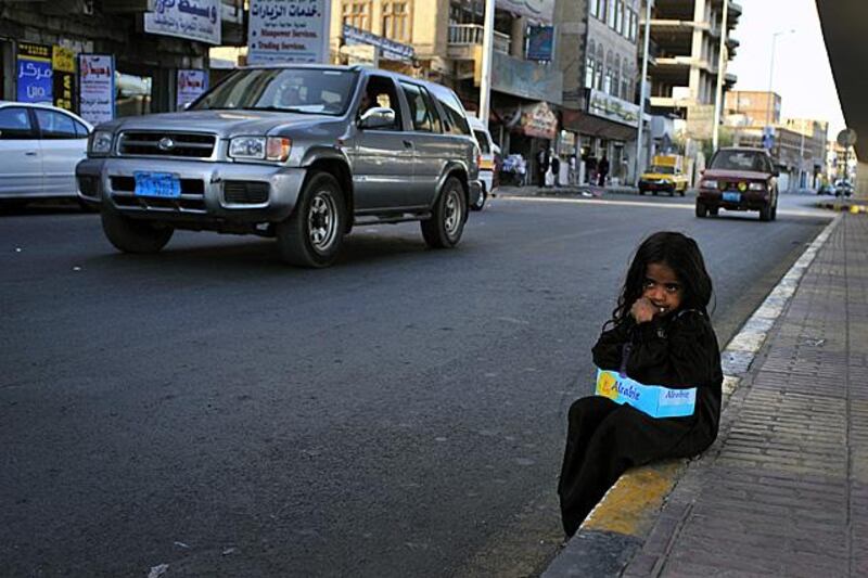 Hamas Hajiri 8, sells tissues to passing drivers at an intersection in downtown Sana'a. Photo: Lindsay Mackenzie for the National.