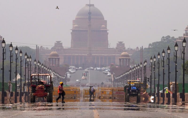 7. New Delhi, India - A construction worker walks across a mirage created on a road following a heat wave, in New Delhi in May. It was 40°C on Thursday. AP