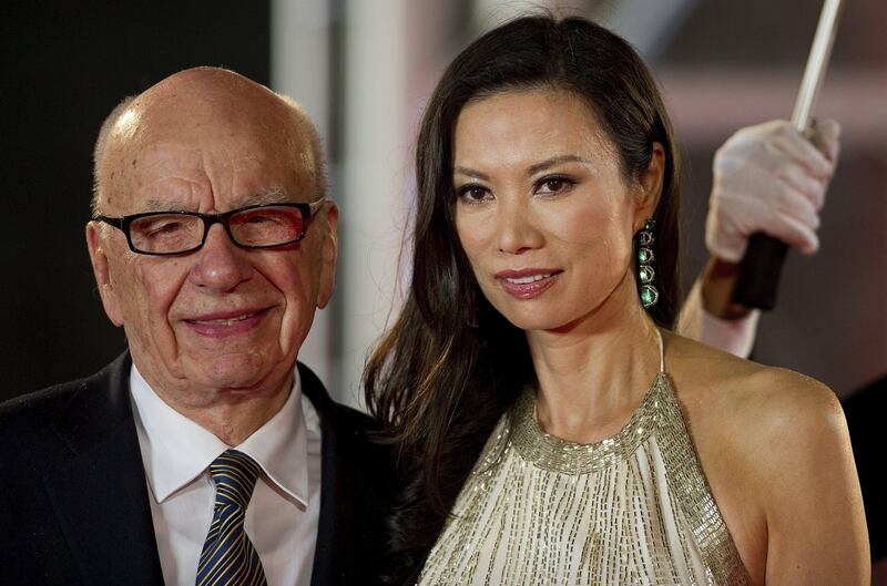 (FILES) This file photo taken on June 11, 2011 shows media executive Rupert Murdoch (L) and his wife Wendi Deng arriving on the red carpet during the opening ceremony of the Shanghai International Film Festival (SIFF) in Shanghai. Wendi Deng, who has emerged as an unlikely heroine after leaping to defend her 80-year-old husband Rupert Murdoch from a pie-wielding protester on July 19, 2011, has a reputation for formidable ambition and fierce loyalty.   AFP PHOTO / FILES / Philippe Lopez
 *** Local Caption ***  454884-01-08.jpg