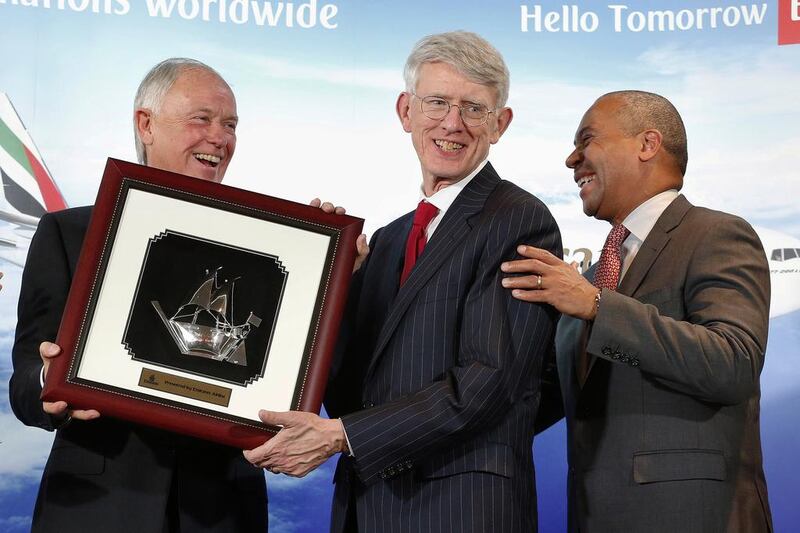 Massachusetts governor Deval Patrick, right, smiles as Emirates Airline president Timothy Clark, left, presents a token to Massport chief executive Thomas Glynn, center, during ceremonies at Logan International Airport in Boston. Michael Dwyer / AP Photo