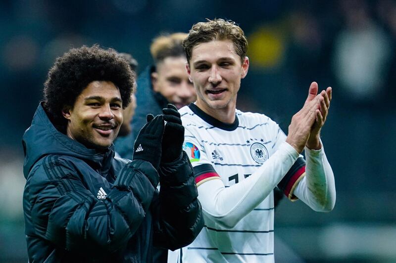 Germany's forward Serge Gnabry (L) and Germany's defender Niklas Stark applaud their fans after the UEFA Euro 2020 Group C qualification football match Germany v Northern Ireland in Frankfurt am Main, western Germany  on November 19, 2019. Germany OUT
 / AFP / dpa / Uwe Anspach
