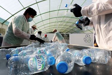 Students of Zayed Higher Organization for People of Determination sorting out plastic bottles during the recycling workshop held at Zayed Agricultural Center for Development and Rehabilitation in Abu Dhabi. Pawan Singh / The National