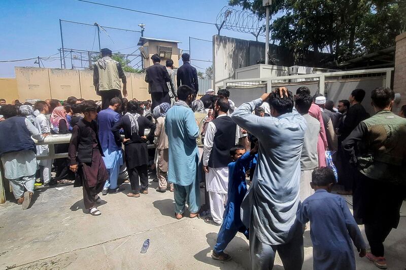 People gather outside the French embassy in Kabul on August 17, waiting to leave Afghanistan. AFP