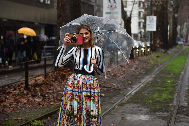 A guest poses in the street on February 28, 2016, before the Dolce Gabbana segment of the Women Autumn / Winter 2016 Milan Fashion Week. Gabriel Bouys / Agence France-Presse