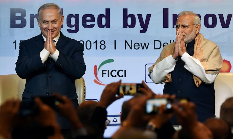 Indian Prime Minister Narendra Modi (R) and Israeli Prime Minister Benjamin Netanyahu greet during the India-Israel Business Summit in New Delhi on January 15, 2018.
Benjamin Netanyahu hailed a "new era" in ties with India on January 15 as he signed a series of deals during the first visit by an Israeli Prime Minister in 15 years. Netanyahu made the comment after talks with Narendra Modi, who made history in July when he became the first Indian leader ever to visit Israel. / AFP PHOTO / MONEY SHARMA