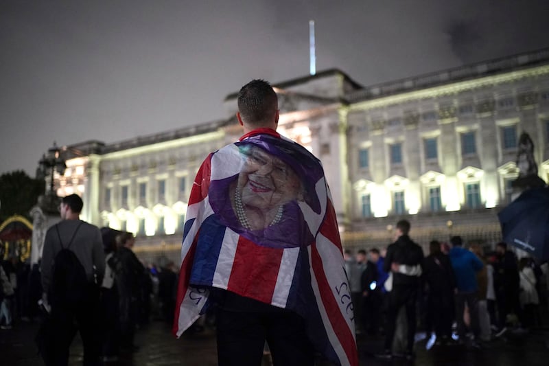 Mourners gather outside Buckingham Palace on Thursday night. PA