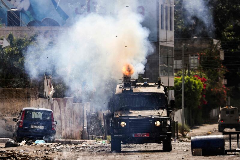 An Israeli armoured vehicle fires tear gas in Jenin city. AFP