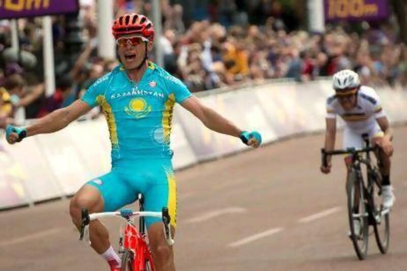 Kazakhstan's Alexandre Vinokourov celebrates as he crosses the finish line after winning the men's road race.