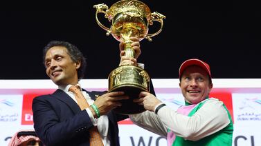 Trainer Bhupat Seemar and Tadhg O'Shea celebrate with the trophy after winning the Dubai World Cup. Reuters