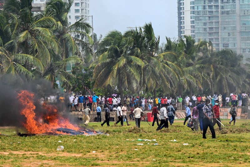 Violence flares between demonstrators and government supporters outside the president's office in Colombo. AFP