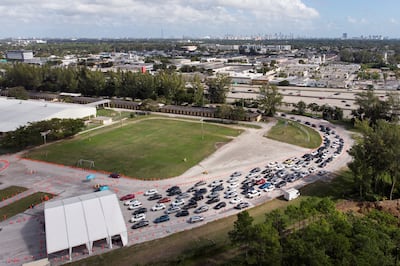 Cars wait in line at a Covid-19 drive-through testing site at Tropical Park in Miami just before Christmas. Reuters