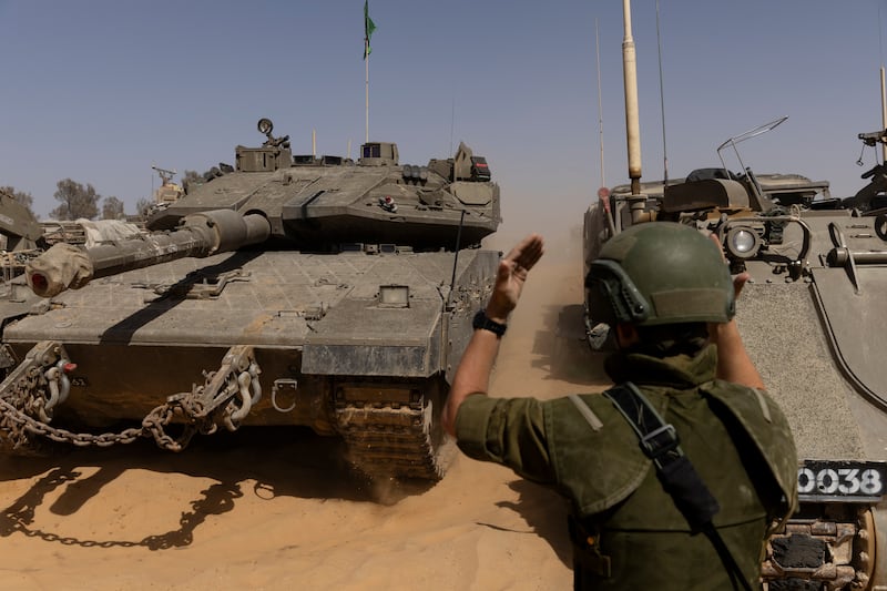 An Israeli soldier directs a tank near Israel's border with southern Gaza. Getty Images