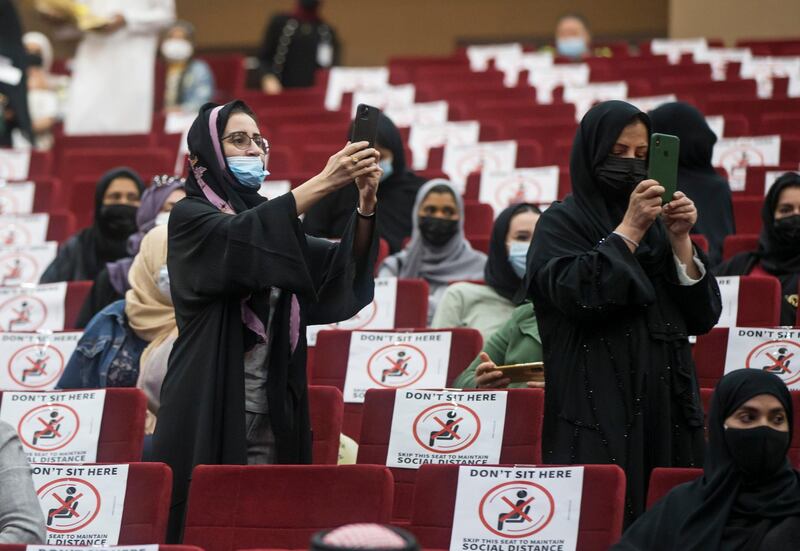 Ajman, United Arab Emirates - Proud relatives of the graduates taking videos and photos of the event at the Al Shola American School first in-person graduation for 12 graders.  Leslie Pableo for The National for Amir's story