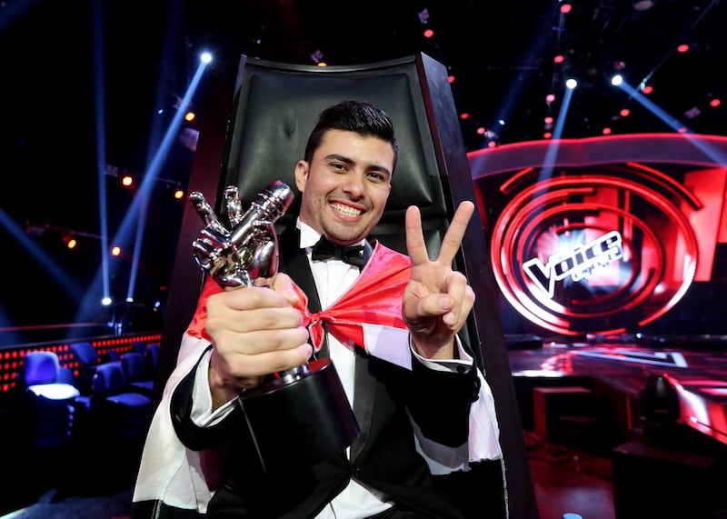 Sattar Saad from Iraq poses with his trophy after winning The Voice. Courtesy Anwar Amro / AFP Photo