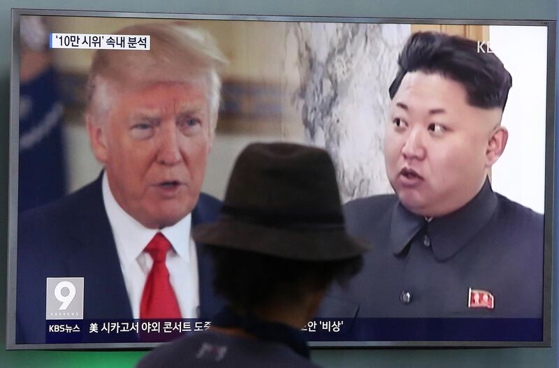 A man watches a television screen showing U.S. President Donald Trump, left, and North Korean leader Kim Jong Un during a news program at the Seoul Train Station in Seoul, South Korea, Thursday, Aug. 10, 2017. North Korea has announced a detailed plan to launch a salvo of ballistic missiles toward the U.S. Pacific territory of Guam, a major military hub and home to U.S. bombers. If carried out, it would be the North's most provocative missile launch to date. (AP Photo/Ahn Young-joon)