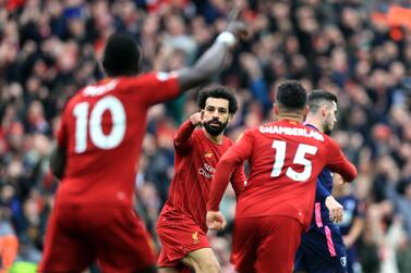 Liverpool's Mohamed Salah (centre) celebrates scoring his sides first goal of the game with teammates during the Premier League match at Anfield, Liverpool. PA Photo. Picture date: Saturday March 7, 2020. See PA story SOCCER Liverpool. Photo credit should read: Mike Egerton/PA Wire. RESTRICTIONS: EDITORIAL USE ONLY No use with unauthorised audio, video, data, fixture lists, club/league logos or "live" services. Online in-match use limited to 120 images, no video emulation. No use in betting, games or single club/league/player publications.