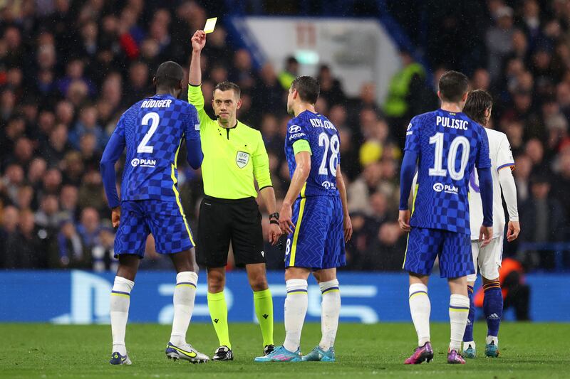 Chelsea defender Antonio Ruediger is shown a yellow card by referee Clement Turpin. Getty