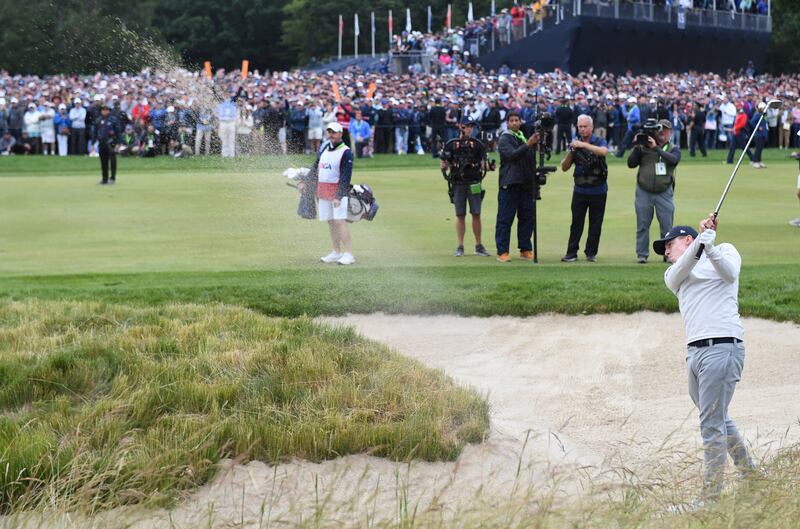 Matt Fitzpatrick of England hits from the bunker to the 18th green. EPA