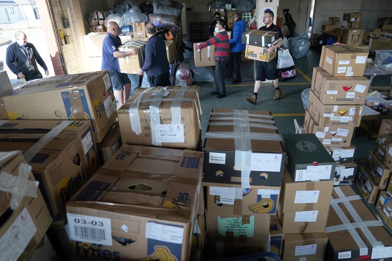 Charity boxes being loaded onto vehicles to be sent to Ukrainian Refugees at a depot in Dumfries, UK, on March 21. PA wire