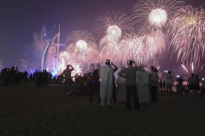 Fireworks celebrating the UAE's 42nd National Day explode over the Burj Al Arab near Umm Suqiem Beach in Dubai. Sarah Dea/The National

