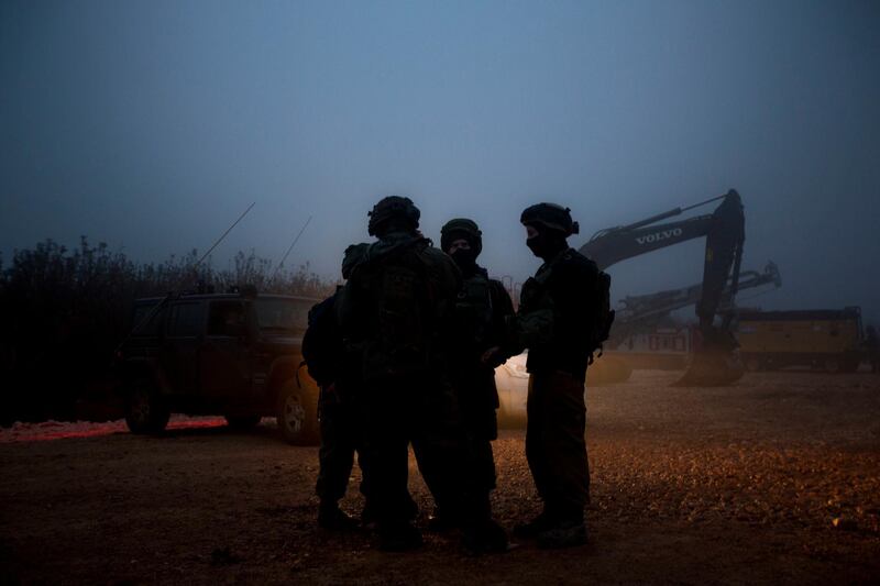 Israeli soldiers stand near the opening of a hole that leads to a tunnel the army says crosses from Lebanon to Israel, near Metula, Wednesday, Dec. 19, 2018. Israel's prime minister Wednesday called on the U.N. Security Council to condemn "wanton acts of aggression" by the Lebanese militant group Hezbollah, designate it a terrorist organization and heighten sanctions on it over attack tunnels it has dug into Israel. (AP Photo/Sebastian Scheiner)