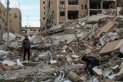 Palestinians search the rubble of destroyed buildings in Beit Lahiya, northern Gaza. AP Photo