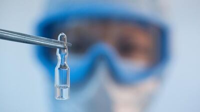 A Russian researcher holds a vial with the Sputnik V vaccine in Zelenograd near Moscow. Reuters