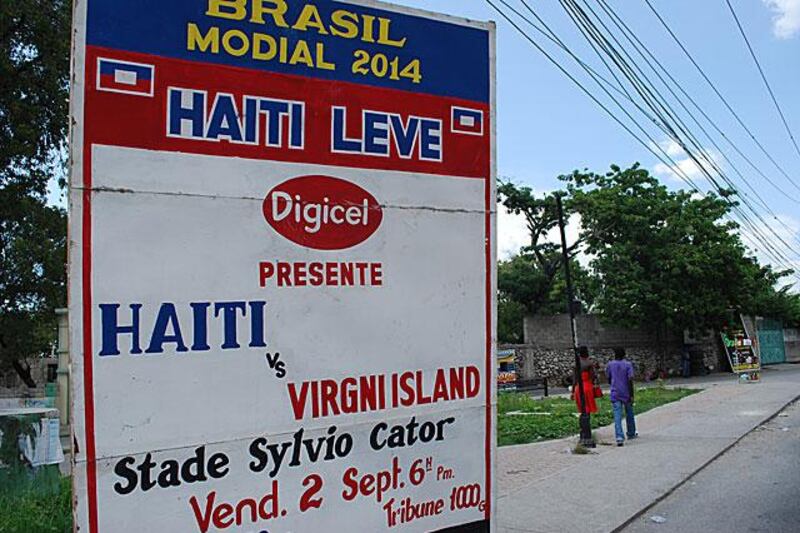 The modest advertising board outside the stadium promotes Haiti's 2014 World Cup qualifier.