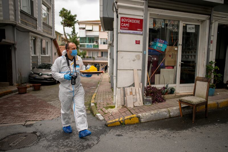 A Turkish forensics officer investigates near the scene of Sunday's church shooting in Istanbul. AP