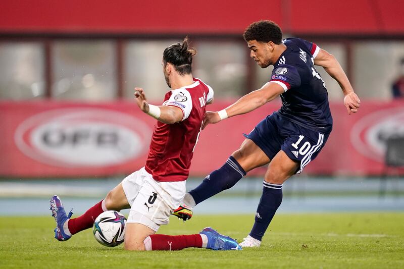 Che Adams of Scotland shoots whilst under pressure from Aleksandar Dragovic of Austria. Getty Images