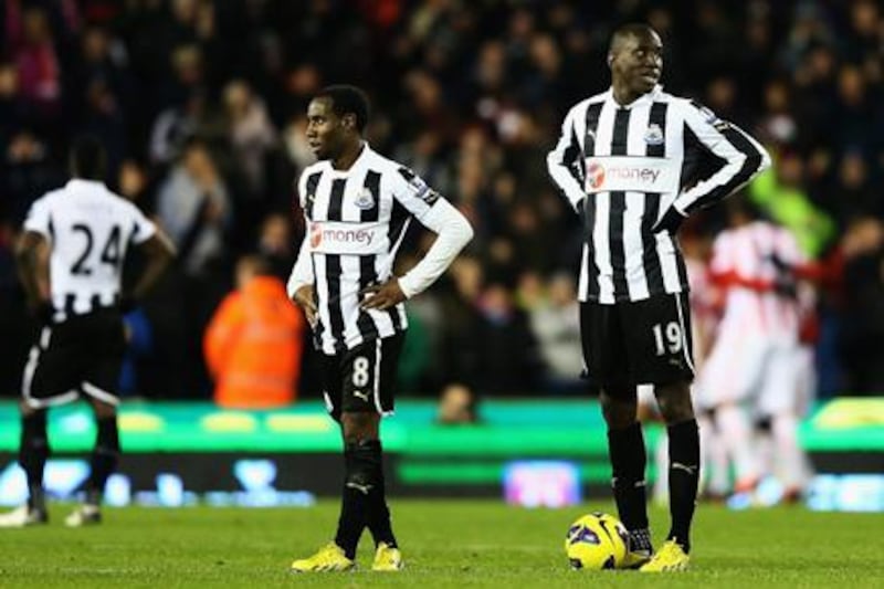 Newcastle's Vurnon Anita and Demba Ba look on as Stoke celebrate Cameron Jerome's goal at the Britannia Stadium.