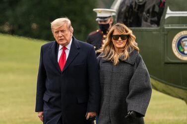 US President Donald Trump and First Lady Melania Trump walk on the South Lawn of the White House on Thursday, December 31, 2020. Bloomberg