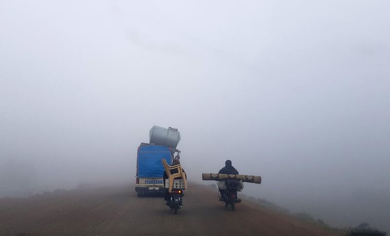 Motorcycles and vehicles loaded with furniture and other items drive along a highway near Sarmada in Syria's northwestern Idlib province, fleeing bombardment in the province's south on their way to areas near the Syrian-Turkish border.  AFP